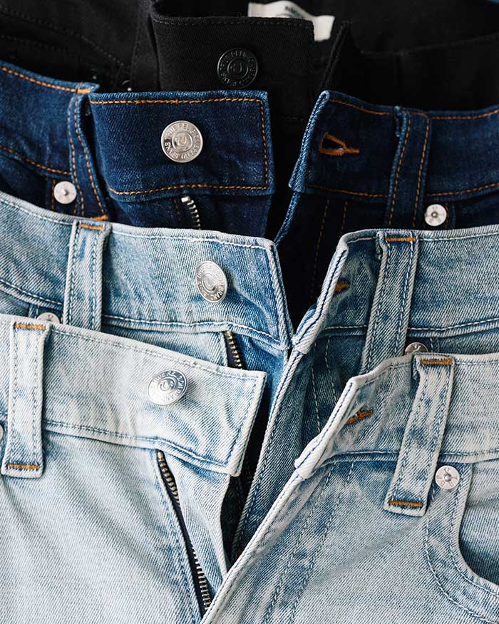 Close up of true religion jeans in light, medium, and dark washes