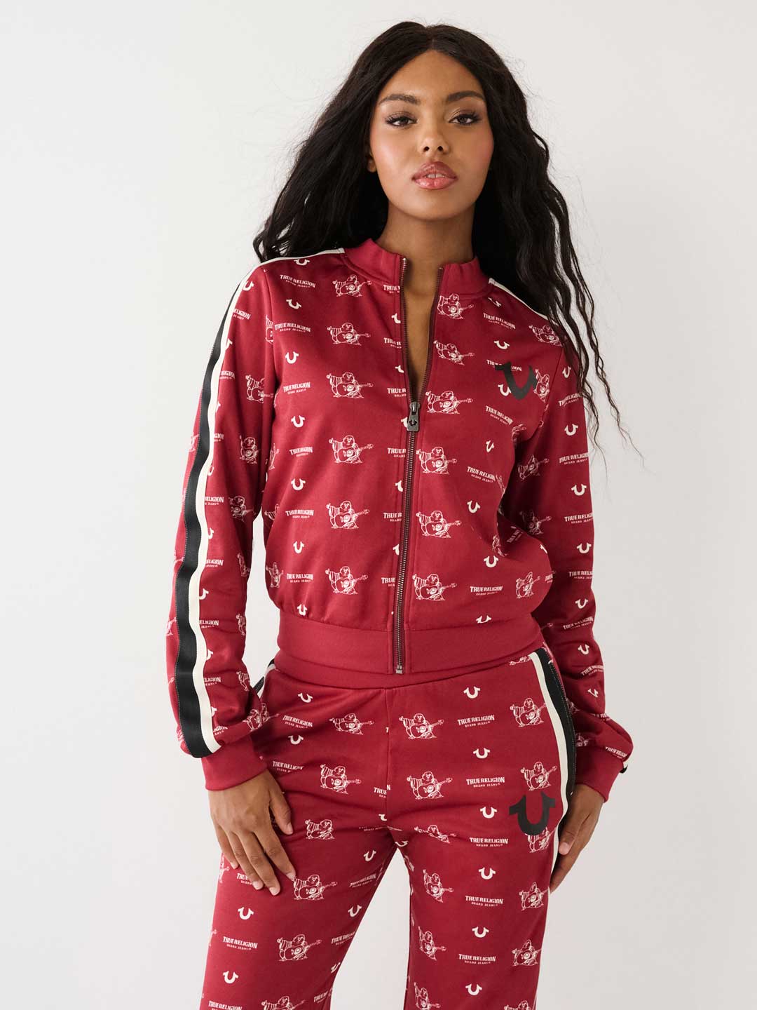 woman wearing a red and white true religion sweat set