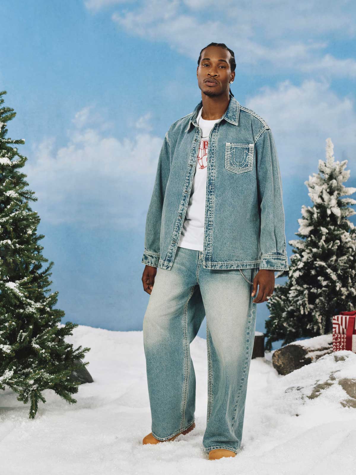 man wearing true religion straight hem super qt denim shirt and baggy light washed jeans