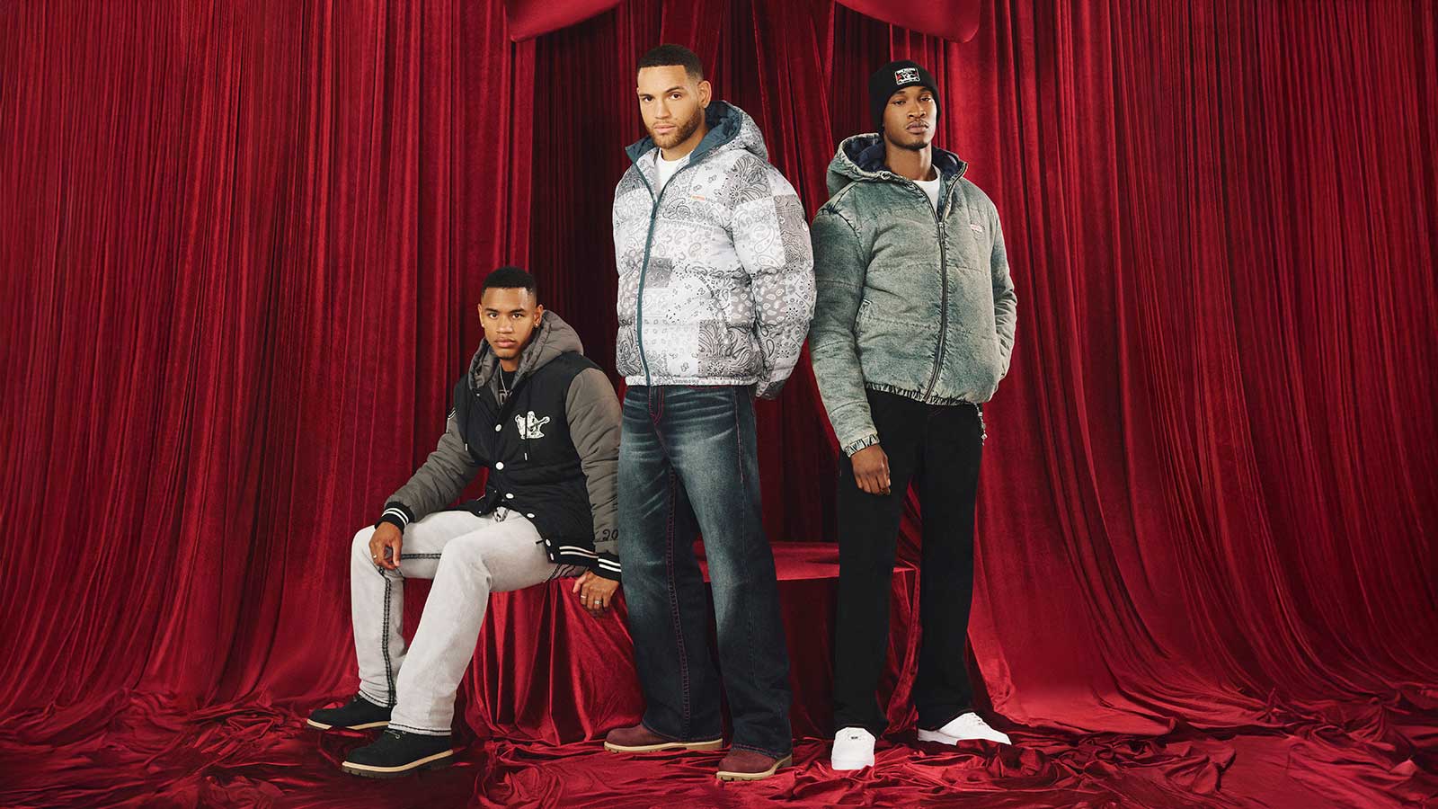 three men wearing true religion winter holiday outfits including hooded jackets, jeans, and sweatpants