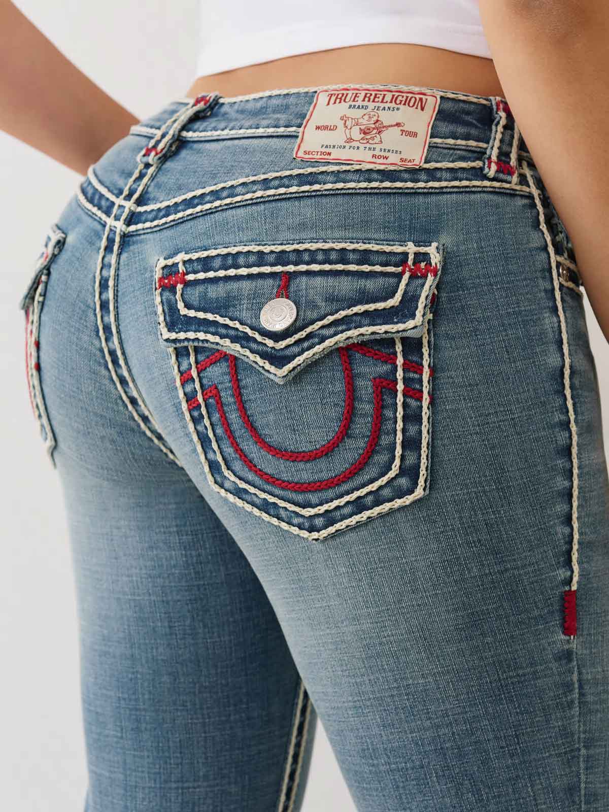 Close up of true religion jeans with red and white stitching details