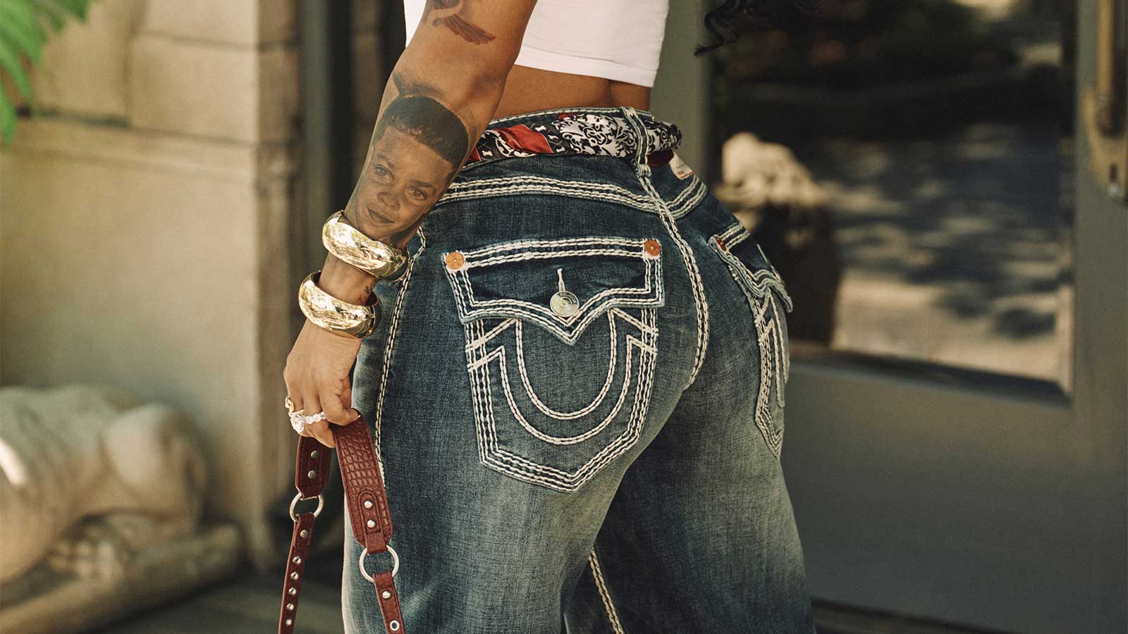 woman wearing true religion bailey super qt barrel jean and baddie top