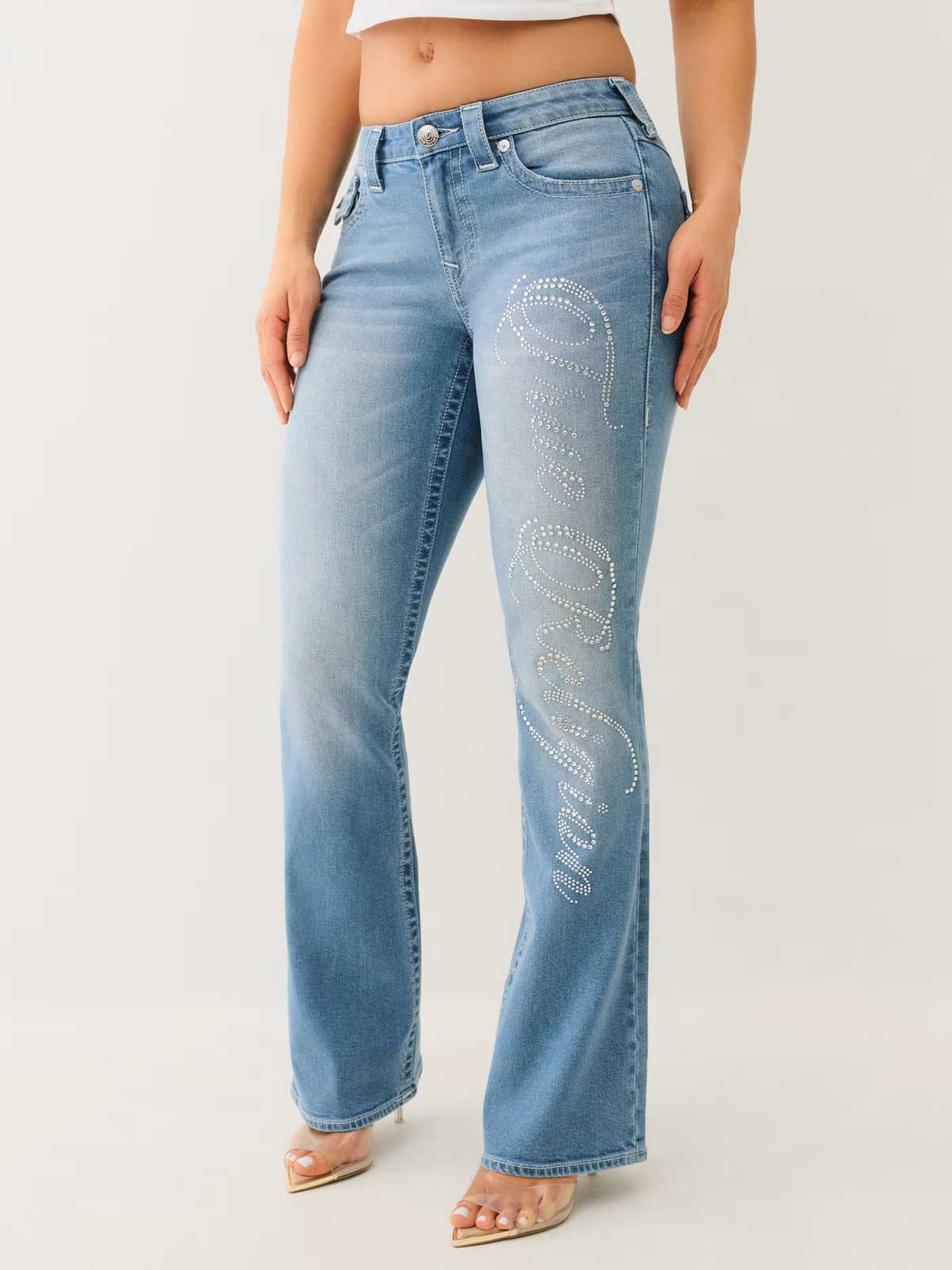 woman wearing true religion becca crystal mid rise bootcut jean with sparkly denim