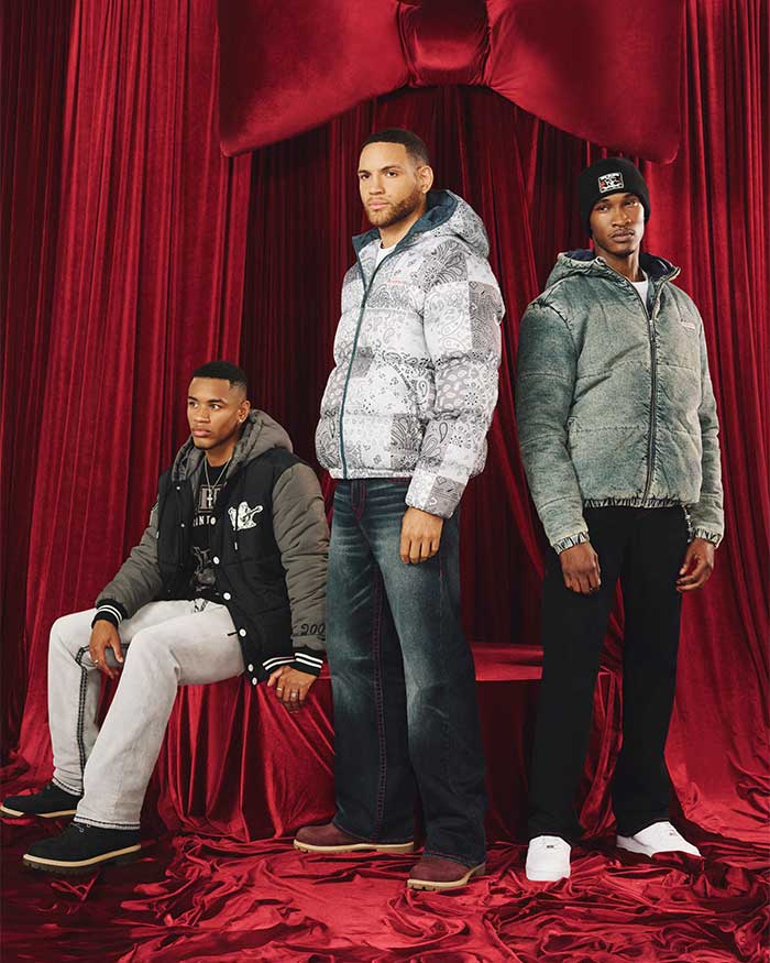 three men wearing true religion winter holiday outfits including hooded jackets, jeans, and sweatpants
