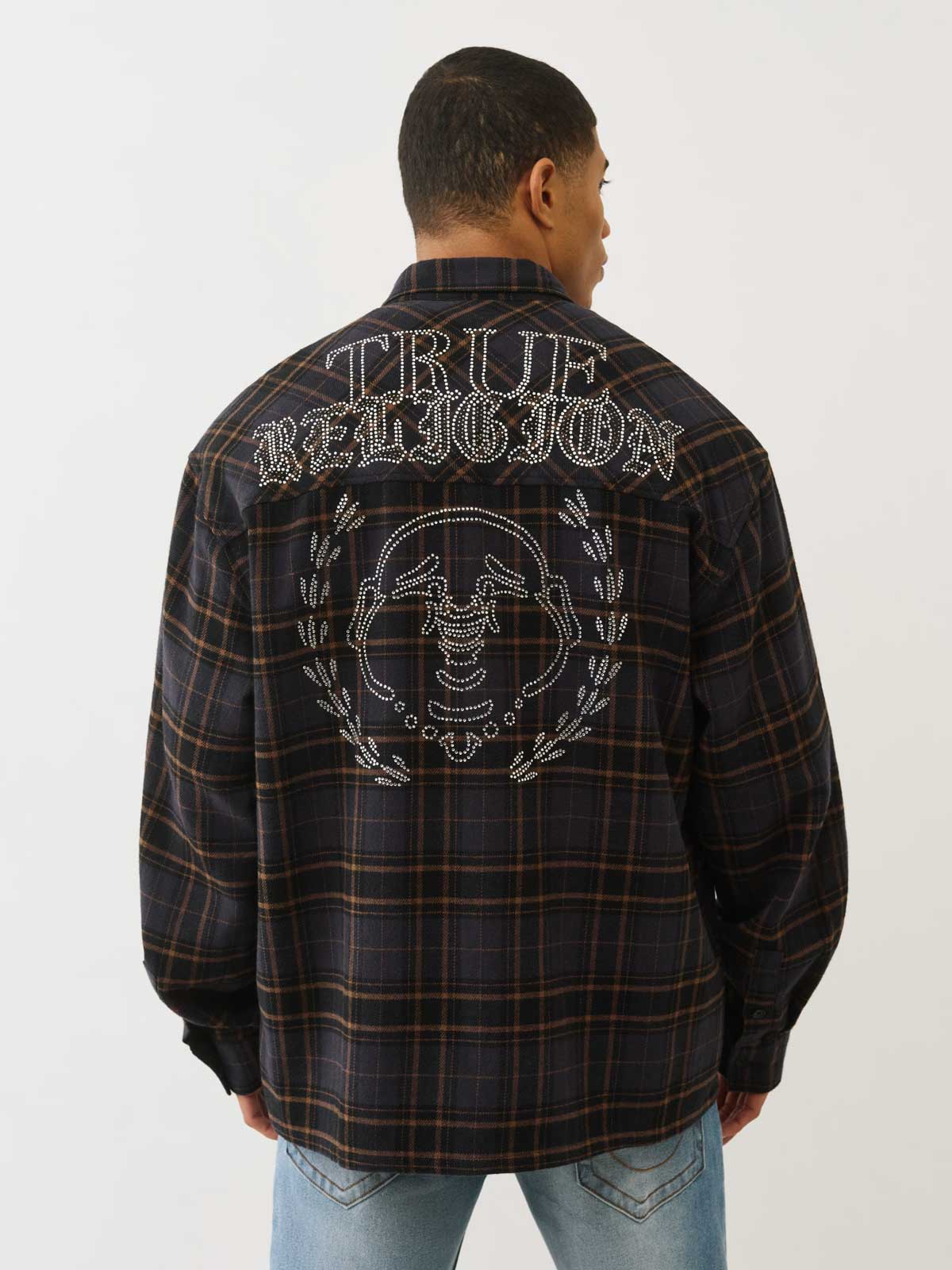 Man wears true religion flannel jacket with white stitch detailing